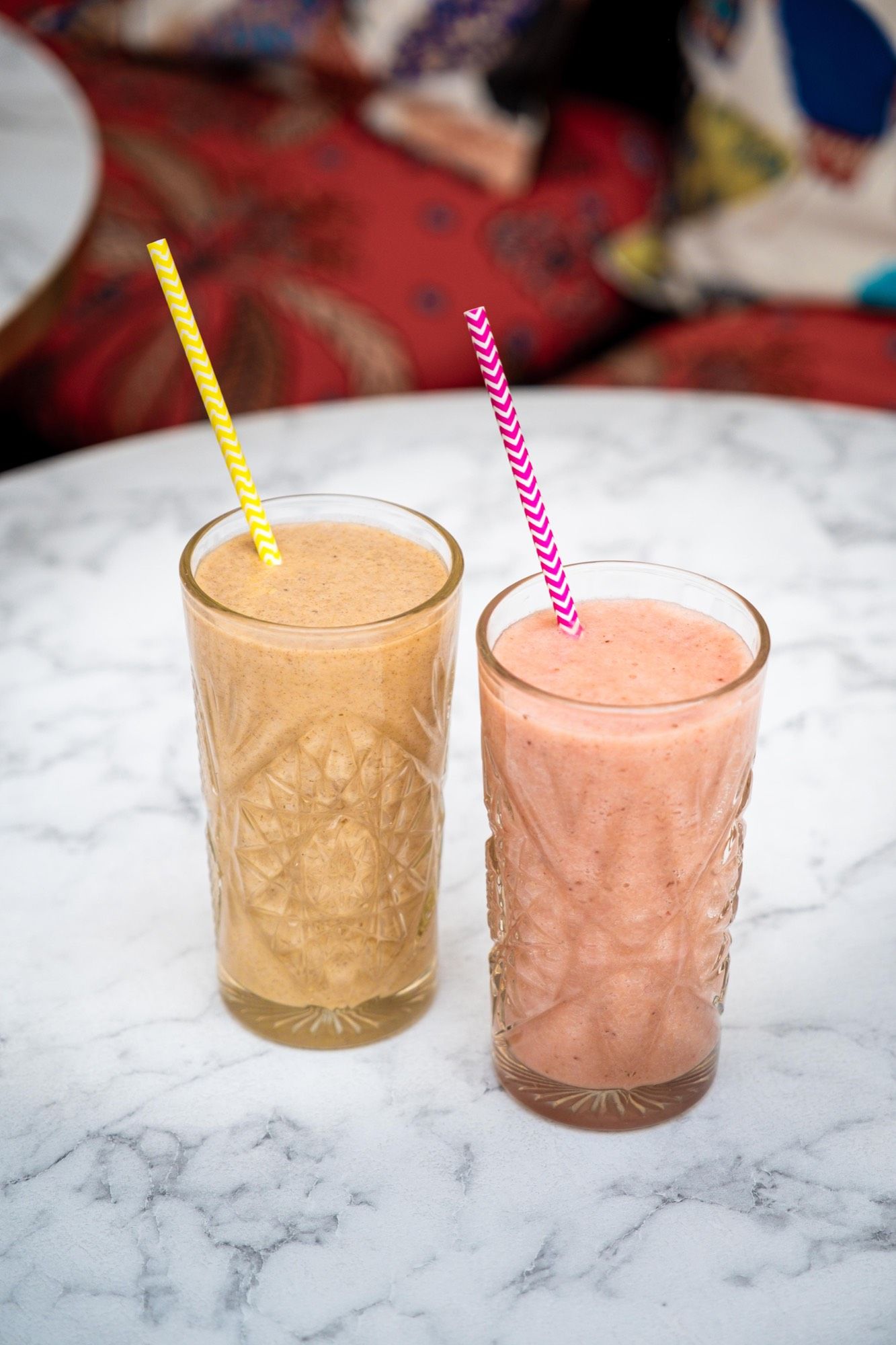 Deux smoothies maison en gros plan, textures épaisses et fruits mixés à la minute